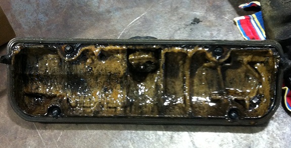 Inside view of the valve cover filled with muck